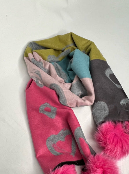 100% viscose scarf Large heart + abstract shape print Color blocking: charcoal, green, teal, and hot pink Hot pink fox fur poms