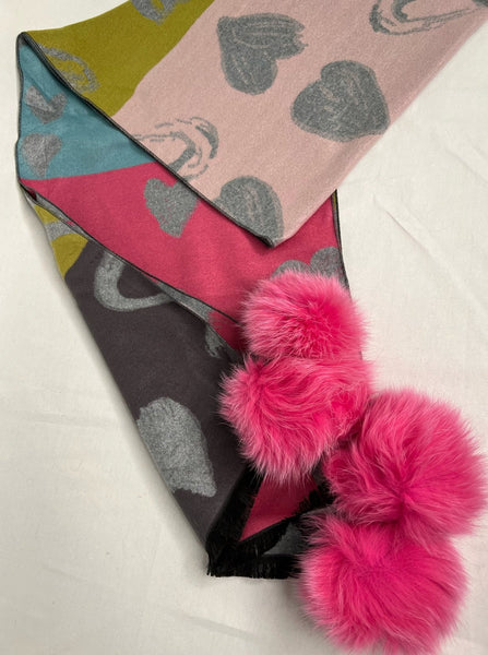 100% viscose scarf Large heart + abstract shape print Color blocking: charcoal, green, teal, and hot pink Hot pink fox fur poms